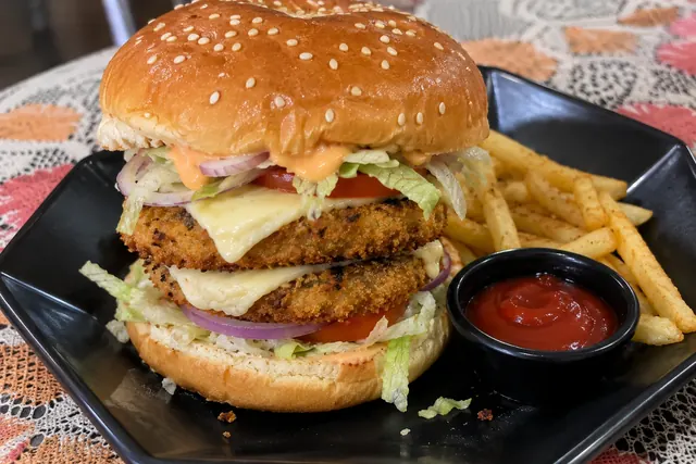 Double-patty YOLO Burger with melted cheese, fresh veg and spiced fries