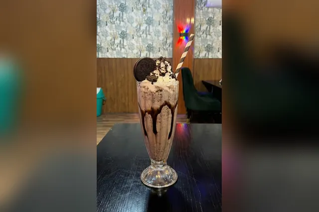 Oreo shake with cookie crumble and chocolate syrup