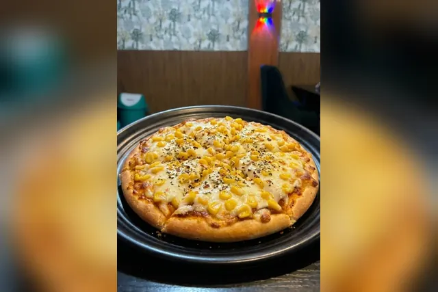 Corn pizza topped with sweet corn and melted cheese
