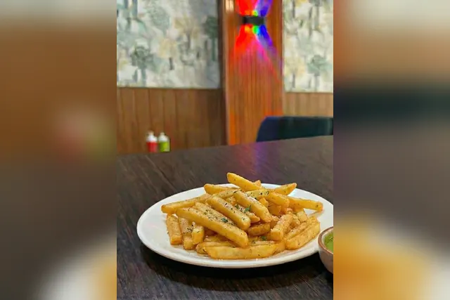 Crispy French fries served on a white plate