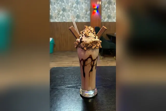 KitKat shake topped with whipped cream and chocolate sauce