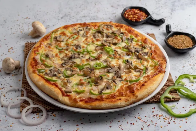 Mushroom and capsicum pizza on a white plate